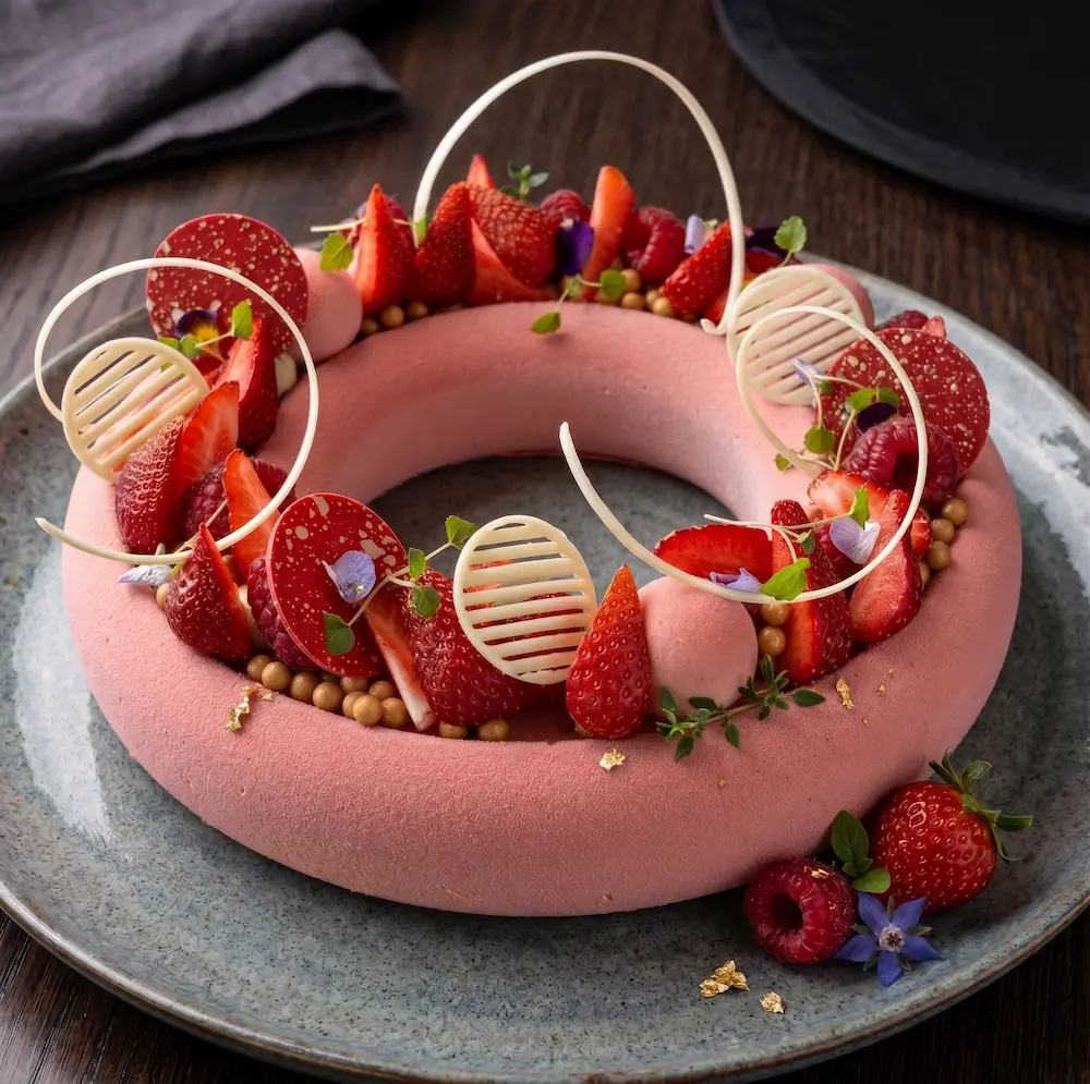Elegant strawberry dessert cake with fresh berries and decorative chocolate details